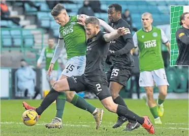  ??  ?? Hibs’ Kevin Nisbet is challenged by Nicky Devlin of Livingston