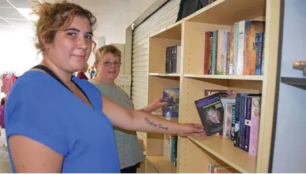  ?? Photo: Jayden Brown ?? BOOK HEAVEN: Lifeline volunteers Melissa Parker (left) and Veronica Betts browse through some of the books at a previous Warwick Daily News Lifeline Bookfest.