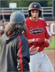  ?? JON BEHM — THE MORNING JOURNAL ?? Lutheran West senior Alex Robinson talks with Lutheran West coach Trey Lamb after hitting a triple in the top of the seventh inning.