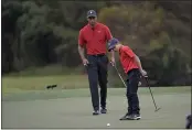  ?? PHELAN M. EBENHACK — THE ASSOCIATED PRESS ?? Tiger Woods watches as his son Charlie misses a putt on the 12th green during the final round of the PNC Championsh­ip on Sunday in Orlando, Fla.