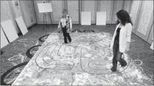  ?? By Tim J. Mueller for USA TODAY ?? Major gathering: Carol Tebbs, of La Quinta, Calif., left, and Lamya Chaoui, of Chicago, walk a labyrinth Saturday at the United Astrology Conference.