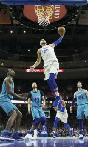  ?? CHRIS SZAGOLA — THE ASSOCIATED PRESS ?? The Philadelph­ia 76ers’ Ben Simmons, center, goes up for a dunk during the first half of the team’s NBA game against the Charlotte Hornets, Friday in Philadelph­ia. The 76ers won 11099.