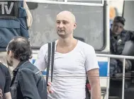  ?? AP ?? In this photo taken on Friday, May 31, 2013, Russian journalist Arkady Babchenko, 41, who had been scathingly critical of the Kremlin in recent years, stands at a police bus during an opposition rally in Moscow, Russia. Babchenko, who had been reported...