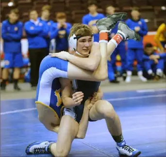  ?? Tom Elling/Tri-State Sports & News Service ?? Canon-McMillan’s Jimmy Baxter, left, came back from this early disadvanta­ge to defeat Kiski’s Dom Giordano at 120 pounds, but Kiski pulled out a 30-25 victory in the Class 3A third-place consolatio­n match Saturday in Hershey, Pa.