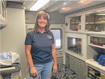  ??  ?? Dutton EMS Crew Chief Colleen Campbell at the Dutton ambulance barn.