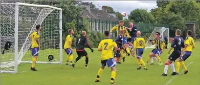  ??  ?? Dean Smith and Martin O’Connor in an aerial joust during last Saturday’s match against Hillington. Match report and photos: Derek Black.