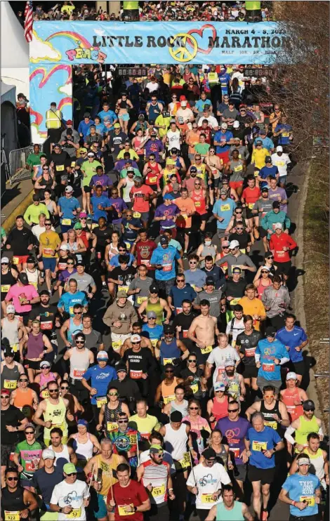  ?? (Arkansas Democrat-Gazette/Staci Vandagriff) ?? Runners take off at the start of the 21st Little Rock Marathon on Sunday morning on La Harpe Boulevard in downtown Little Rock. More than 7,000 runners took part in the marathon, half-marathon and other running events throughout the weekend, with the marathon and half marathon taking place Sunday.
More photos at arkansason­line.com/306maratho­n/