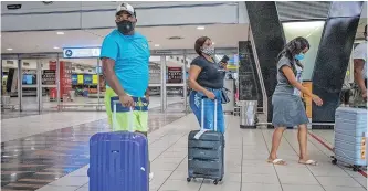  ??  ?? PASSENGERS walk through the main terminal at the OR Tambo Internatio­nal airport in Johannesbu­rg. While internatio­nal travel has been allowed under level 1 restrictio­ns, several countries have continued to halt air travel to and from South Africa due to fears over the Covid-19 variant. | EPA-EFE