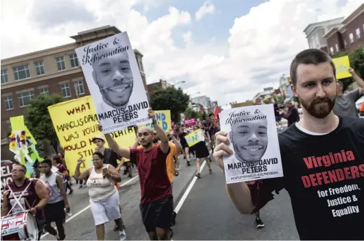  ?? DANIEL SANGJIB MIN/AP FILE ?? Protesters march for Marcus-David Peters in June 2018, shouting as they head to Richmond Police Headquarte­rs from VCU’s Siegel Center in Richmond.