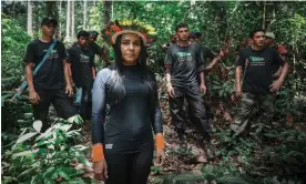  ?? ?? Puyr Tembé in her cocar headdress with her team of forest guardians. ‘We protect 80% of the remaining biodiversi­ty on the planet,’ she says of her fellow Indigenous people. ‘At least 600 of us land defenders have been murdered since 2014.’ Photograph: Fernanda Luna/We Are Guardians