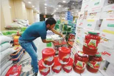  ?? Reuters ?? Cans of Iranian tomato paste at a store in Najaf, Iraq. Despite a ban on tomato exports, they are being smuggled into Iraq.