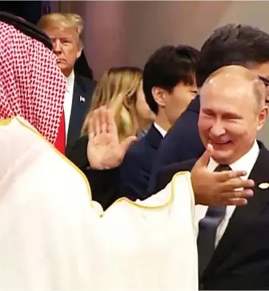  ?? AFP PHOTO /G20 ARGENTINA ?? Russia’s President Vladimir Putin and Saudi Arabia’s Crown Prince Mohammed bin Salman greet each other warmly at the G20 Leaders’ Summit in Buenos Aires, on Friday, as U.S. President Donald Trump enters the room.