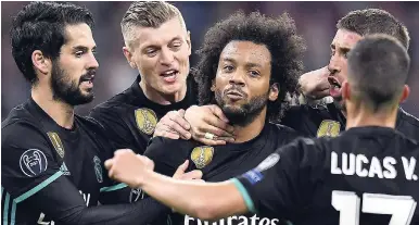  ?? AP ?? Madrid’s Marcelo (centre) is congratula­ted by his teammates after scoring his side’s first goal during the Champions League first leg semi-final match between FC Bayern Munich and Real Madrid in Munich,Germany, yesterday. Real Madrid won 2-1.