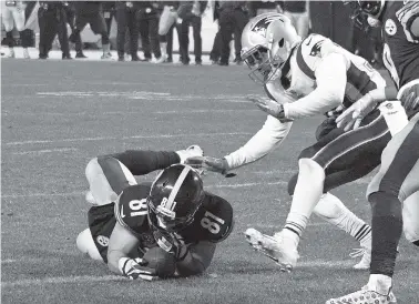  ?? ASSOCIATED PRESS FILE PHOTOS ?? Pittsburgh Steelers tight end Jesse James loses his grip on the football after crossing the goal line on a pass play against the New England Patriots in the closing seconds of the fourth quarter during the Dec. 17 game in Pittsburgh. While coaches,...