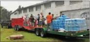  ?? SUBMITTED PHOTOS ?? Members of the Boyertown Area High School football team help to load cases of water on the trucks.
