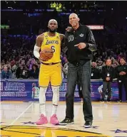  ?? Ashley Landis/Associated Press ?? Los Angeles Lakers forward LeBron James, left, poses with Kareem Abdul-Jabbar after passing Abdul-Jabbar to become the NBA’s all-time leading scorer during the second half against the Oklahoma City Thunder on Tuesday in Los Angeles.