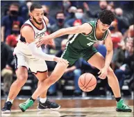  ?? Stephen Dunn / Associated Press ?? UConn’s Tyrese Martin, left, attempts a steal from Binghamton’s Kellen Amos on Saturday in Hartford.