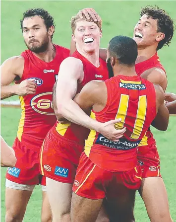  ?? Picture: JONO SEARLE ?? SUN GUN: Matt Rowell (centre) celebrates a goal with teammates.