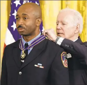  ?? GETTY IMAGES ?? President Biden awards FDNY Firefighte­r Abraham Miller the Public Safety Officer Medal of Valor in the White House on Monday. Miller saved a 5-year-old girl and her grandmothe­r from burning building in Washington Heights in 2020.