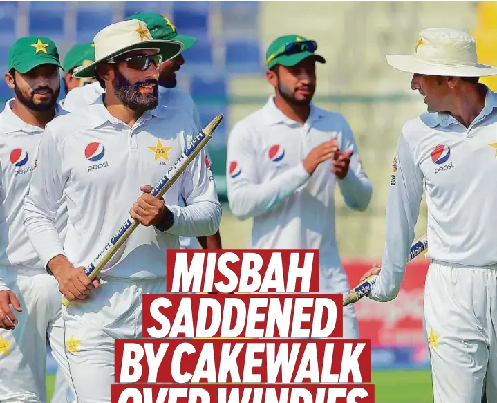  ?? AFP ?? Pakistani captain Misbahul-Haq (left) heads back to the pavilion with teammates after winning the second Test against the West Indies at Shaikh Zayed Cricket Stadium in Abu Dhabi yesterday.