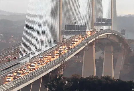  ??  ?? Traffic flows on both carriagewa­ys of the Queensferr­y Crossing — the world’s longest three-tower, cable-stayed bridge.