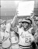  ?? Associated Press file ?? On Aug. 29, 1977, St. Louis Cardinals outfielder Lou Brock became baseball’s all-time leader in stolen bases, surpassing the 892 steals of Ty Cobb. Brock is holding the second base he stole against the Padres to set his record.