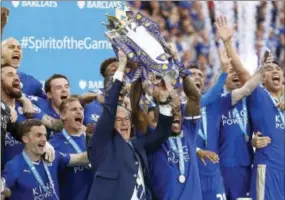  ?? MATT DUNHAM - ASSOCIATED PRESS FILE ?? In this May 7, 2016, photo, Leicester’s manager Claudio Ranieri and team captain Wes Morgan lift the trophy as Leicester City celebrate becoming the English Premier League soccer champions at King Power stadium in Leicester, England. Leicester City,...