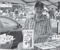  ??  ?? Mark Snodgrass, of OFF the Wall Home Decor, seen here holding of his many paintings, was one of the 200 tables at the flea market that takes place each year.