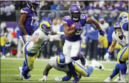  ?? BRUCE KLUCKHOHN - THE ASSOCIATED PRESS ?? Minnesota Vikings running back Alexander Mattison (25) runs from Los Angeles Rams inside linebacker Troy Reeder (51) during the first half of an NFL football game, Sunday, Dec. 26, 2021, in Minneapoli­s.