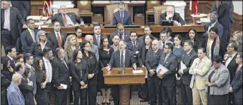  ??  ?? Texas Rep. Rafael Anchia, D-Dallas, at podium, is surrounded by fellow lawmakers as he speaks against an anti-”sanctuary cities” bill.