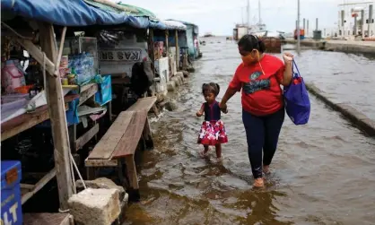  ??  ?? Land subsidence has contribute­d to flooded conditions at the port of Kali Adem, north of Jakarta, Indonesia. Photograph: Willy Kurniawan/Reuters