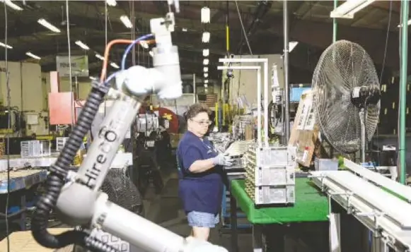  ?? ACKERMAN + GRUBER/FOR THE WASHINGTON POST ?? Annie Larson assembles parts on her line at Tenere, where she’s worked for six years. Although life in rural Wisconsin is tough, she has no plans to leave.