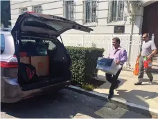  ?? AP ?? Workers carry boxes out of the Russian consulate in San Francisco, one of three missions ordered to close