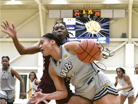  ?? (Pine Bluff Commercial/I.C. Murrell) ?? Maya Peat of UAPB pivots around Alisha Wilson of Alabama A&M in the second quarter Saturday, Jan. 6, 2024, at H.O. Clemmons Arena.