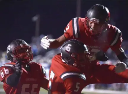  ?? PETE BANNAN — DIGITAL FIRST MEDIA ?? Upper Dublin’s Bryan Derr (66) and Jason Scott (13) embrace Dylan Zlotnikoff (5) after his second-quarter touchdown reception against West Chester Rustin in the District 1-5A final last Friday.