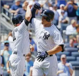  ?? KATHY WILLENS — THE ASSOCIATED PRESS ?? The Yankees’ Brett Gardner, left, greets Aaron Judge after scoring on Judge’s two-run home run during the fourth inning against the Blue Jays in New York Wednesday.