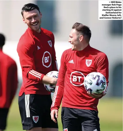  ??  ?? > Will Wales manager Rob Page find a place in his starting XI against Switzerlan­d for Kieffer Moore, left, and Connor Roberts?