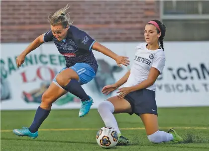  ?? STAFF PHOTO BY DOUG STRICKLAND ?? Pensacola FC’s Keidi Ruth, right, tackles Chattanoog­a FC’s Carlie Banks during their WPSL South Region semifinal match Friday night at Finley Stadium. Pensacola won 6-2.