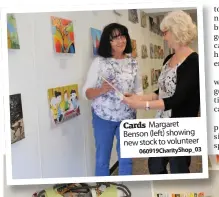  ??  ?? Cards Margaret Benson (left) showing new stock to volunteer