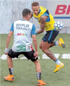  ??  ?? Neymar (right) plays football as he hosts a five-a-side football tournament for his charity Neymar Junior Project Institute, in Praia Grande, Sao Paulo, Brazil. — AFP photo