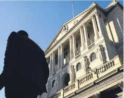  ?? Picture: Getty. ?? A City worker passes by the Bank of England’s headquarte­rs in London.