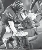  ??  ?? The Memphis defense brings down South Alabama ruling back Tra Minter (right) on Saturday. MARK WEBER/THE COMMERCIAL APPEAL