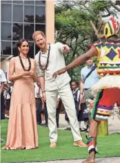  ?? ANDREW ESIEBO/GETTY IMAGES FOR THE ARCHEWELL FOUNDATION ?? Prince Harry and Duchess Meghan watch a dance being performed at the Lightway Academy Friday during their visit to Abuja, Nigeria.