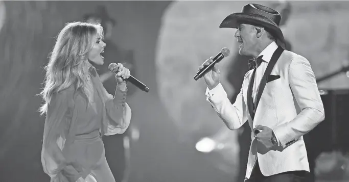  ?? LARRY MCCORMACK / TENNESSEAN. COM ?? Faith Hill and Tim McGraw sing their single “The Rest of Our Life” at the CMA Awards in Nashville.