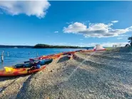  ?? ?? Kayaks sit on the beach during a Kayak Campout event held at Lake Ouachita State Park last year. (Submitted photo)