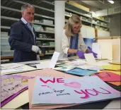  ??  ?? Jan Ramirez, chief curator at the 9/ 11 Memorial & Museum, right, sifts through a collection of condolence cards for a victim of Sept. 11 that were donated to the museum’s archive in Jersey City, N.J. Over the years, the museum has collected some 22,000persona­l artifacts to help tell the stories of those who died and survived.