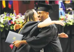  ??  ?? Graduate Josh Cam, of Stamford, hugs professor Suzanne Lyons during Tuesday’s ceremony.