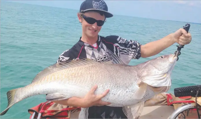  ??  ?? Nick Hooper with a 139cm black jewfish caught a while back off the Nightcliff coast. It took him 30 minutes to get the monster to the boat