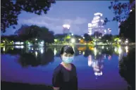  ?? Associated Press ?? Nantaga Sanguannoi during her evening walk at Lumpini park Bangkok, Thailand, on Tuesday. Sanguannoi works as a registered nurse in a hospital in Bangkok. “I want everyone to know it is easy to prevent spreading of COVID-19 by wearing a mask.”