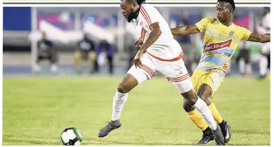  ?? RICARDO MAKYN/MULTIMEDIA PHOTO EDITOR ?? Portmore United’s Ricardo Morris (left) is tackled by Waterhouse’s Cardel Benbow during the Red Stripe Premier League final at the National Stadium last night. Full report in THE STAR and on www.jamaica-gleaner.com.